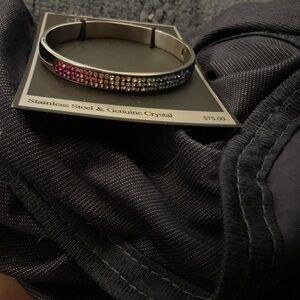 New with tag, beautiful multi colored crystal bangle, has a latch to open.